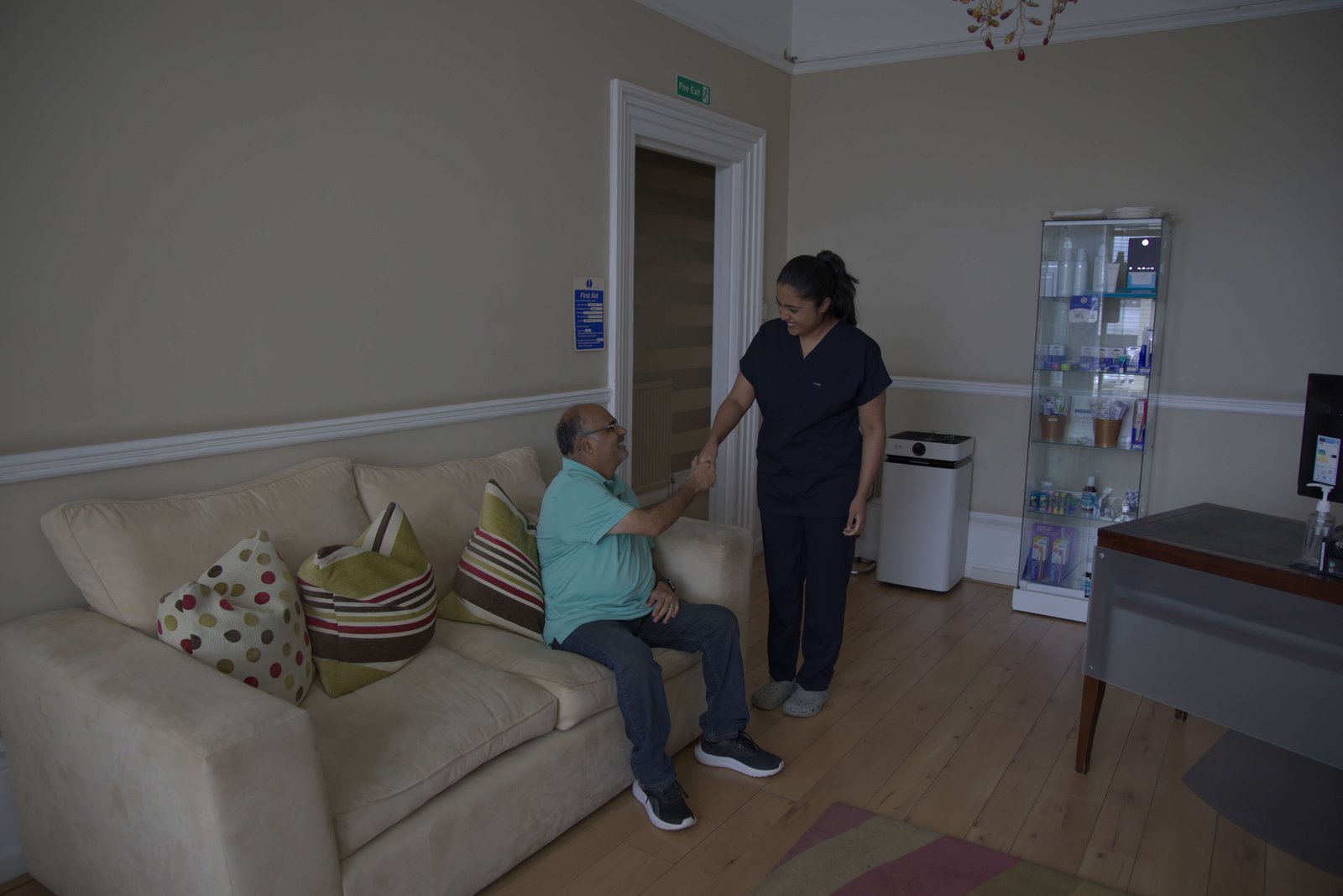 Nurse warmly greeting a patient in the waiting room